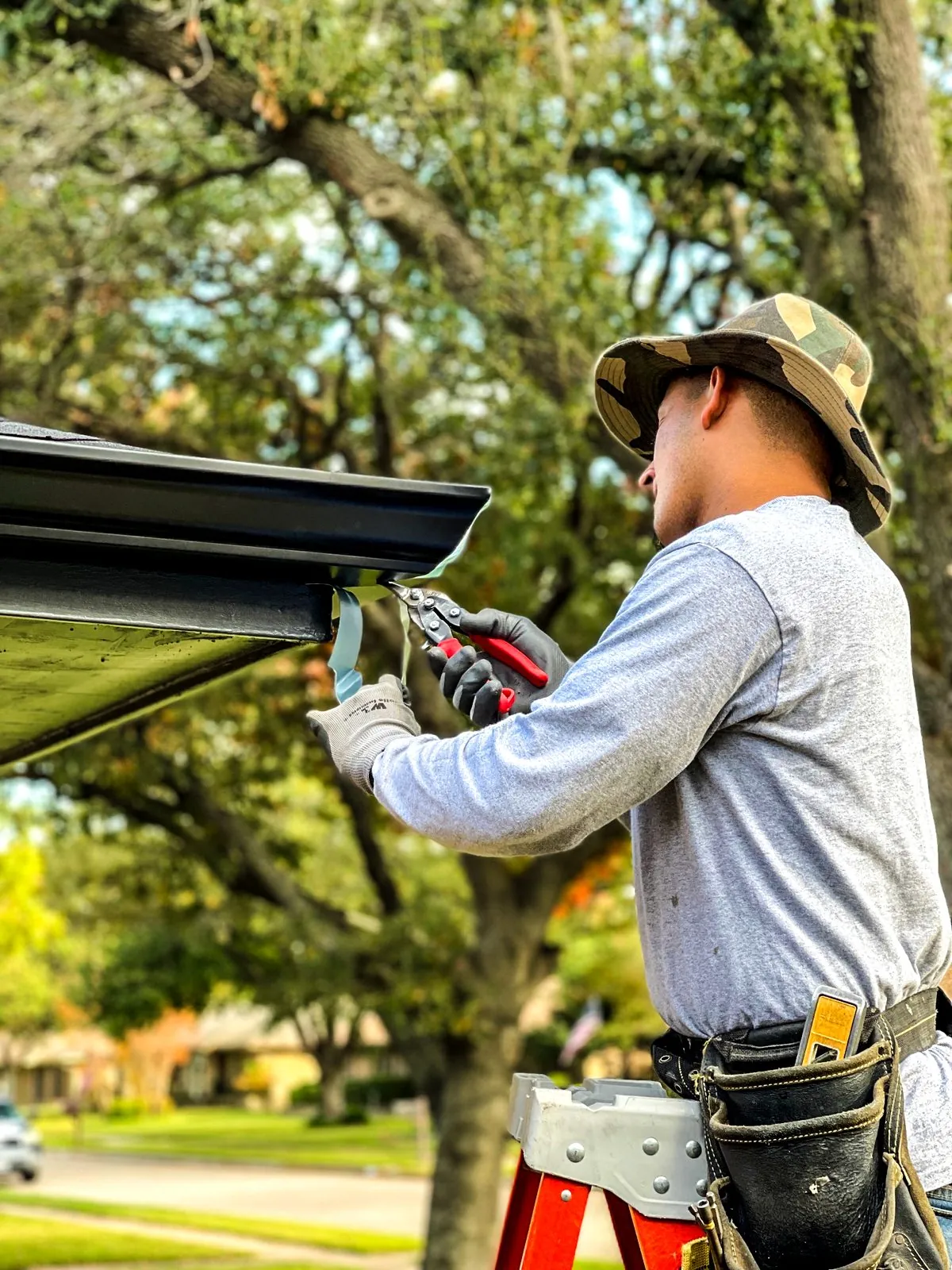 Worker installing gutters