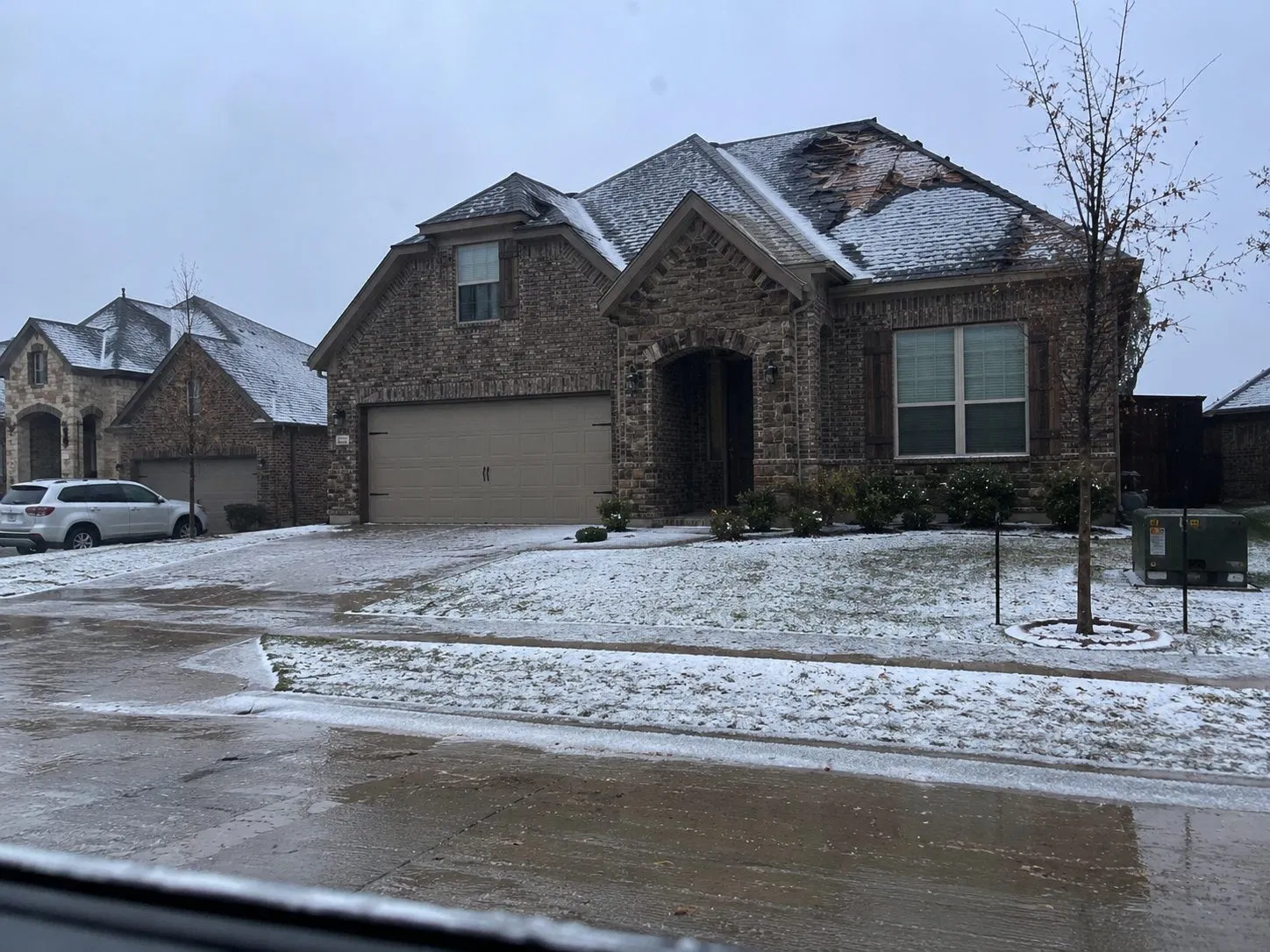 Hail-covered driveway and roof after a DFW hailstorm
