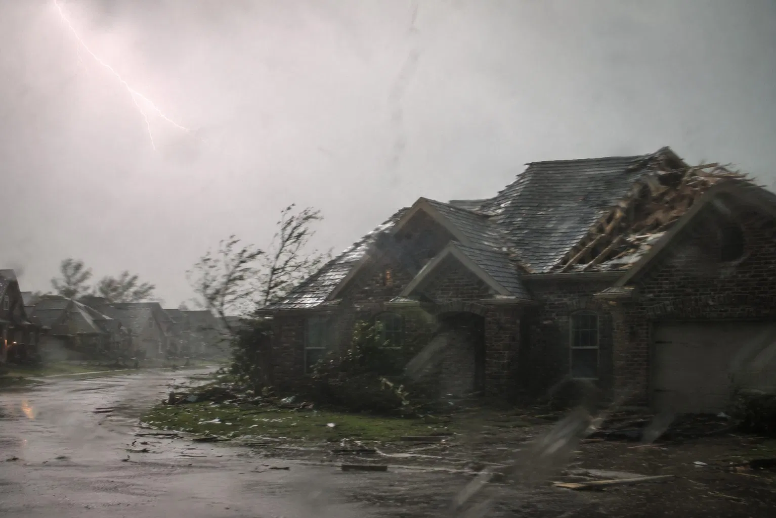 Wind and storm damaged home with lightning