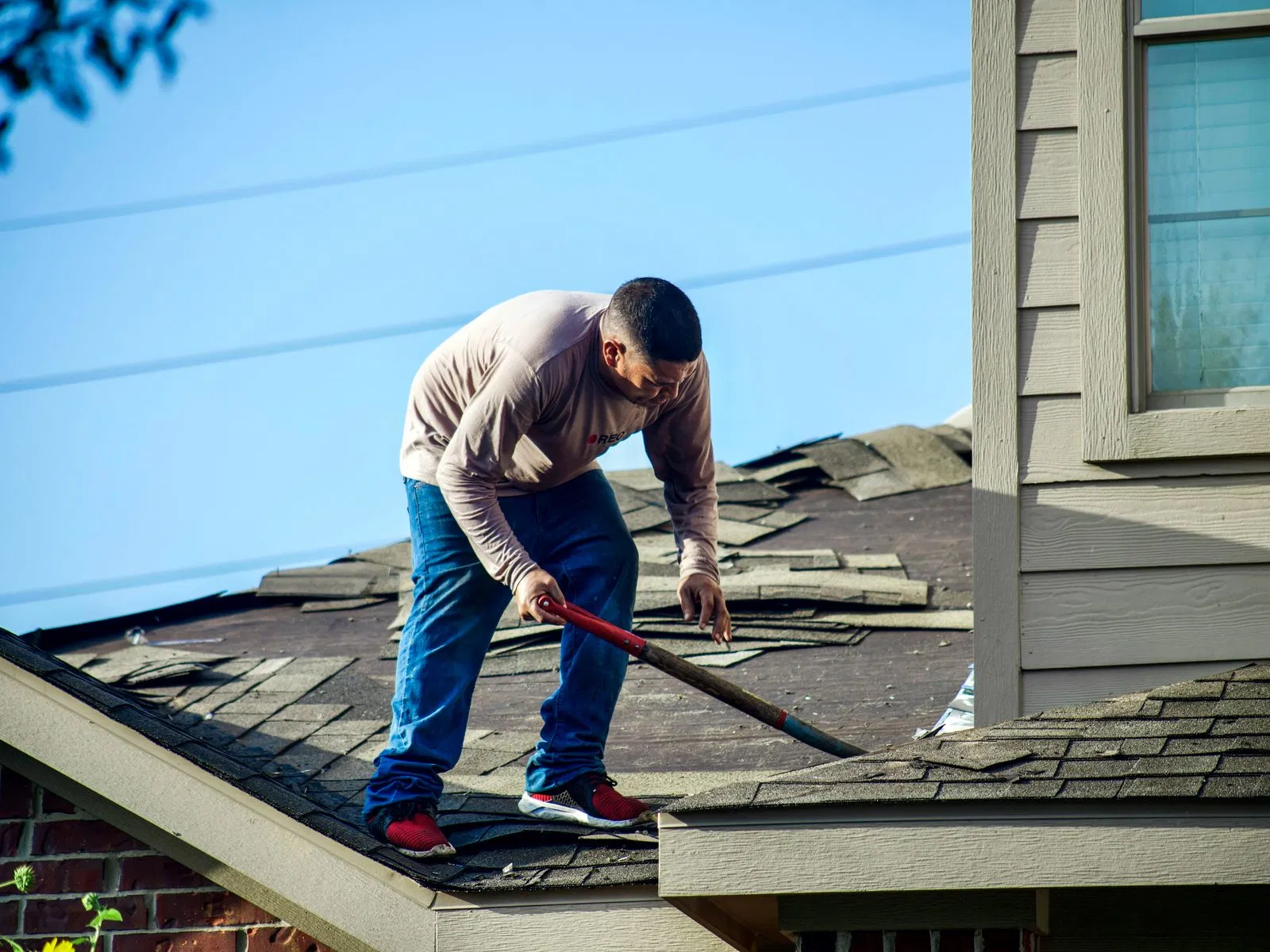 Firewheel Roofing crew tearing off and replacing a roof in Garland Texas