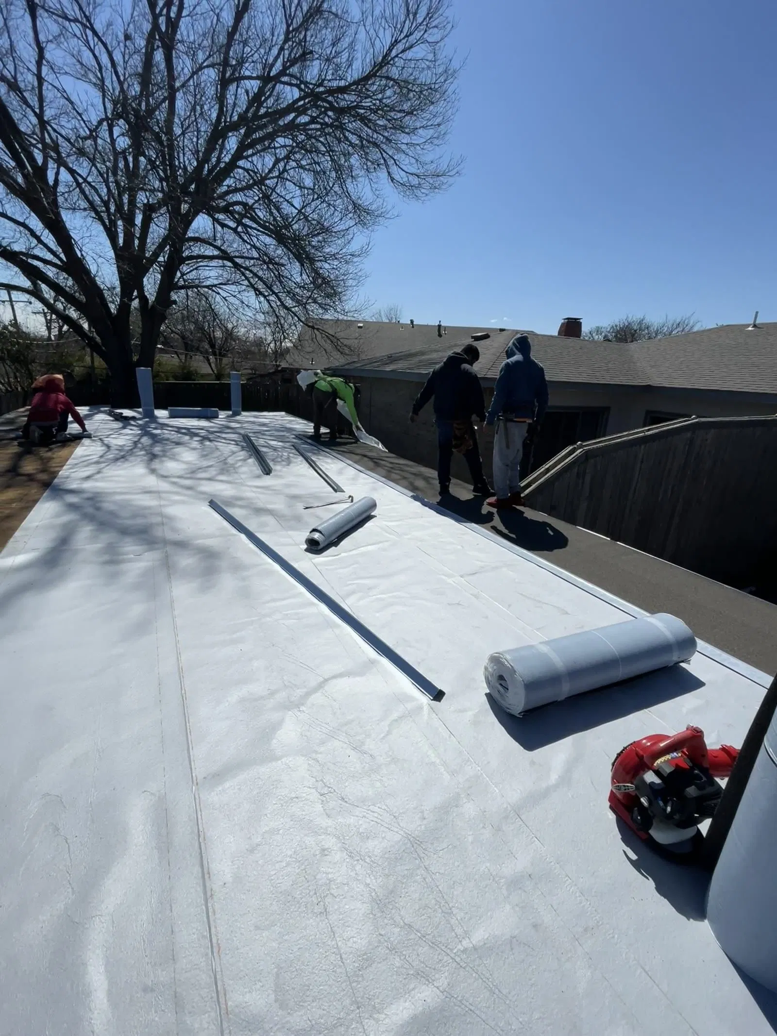 White TPO flat roof with crew